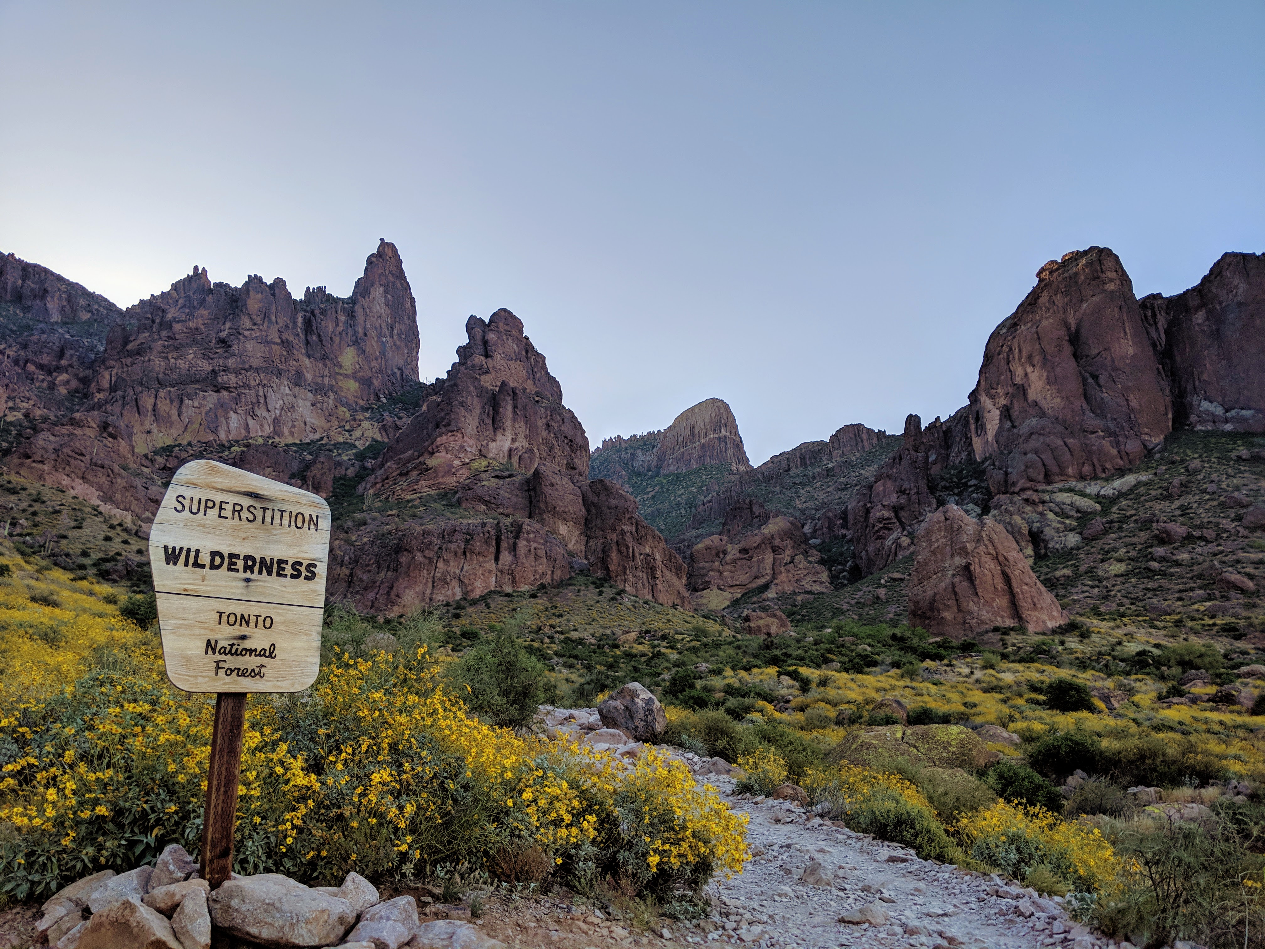 Photo by Gavin McGimpsey of the Flatiron in the Superstition Wilderness, along with the Forest Service sign marking the entrance to the wilderness area.